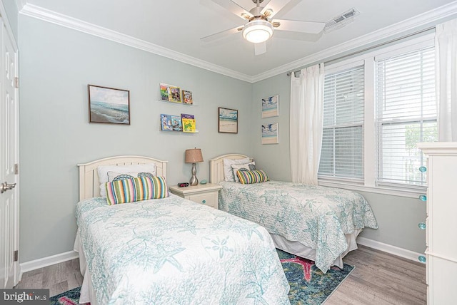 bedroom featuring crown molding, ceiling fan, and light wood-type flooring