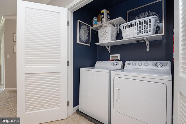 laundry area featuring washer and dryer and light tile patterned floors