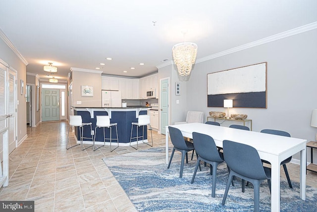 dining space featuring crown molding