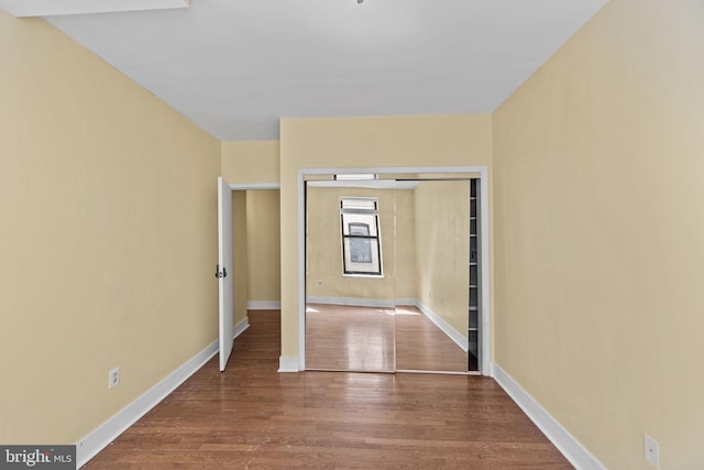 unfurnished bedroom with hardwood / wood-style flooring and a closet