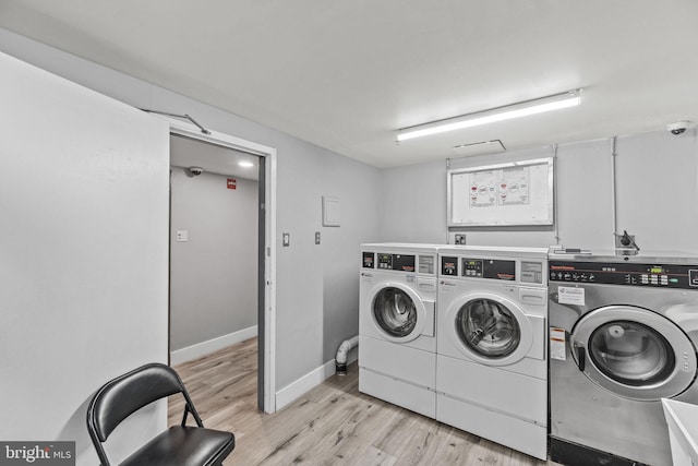 laundry room with light hardwood / wood-style flooring and independent washer and dryer