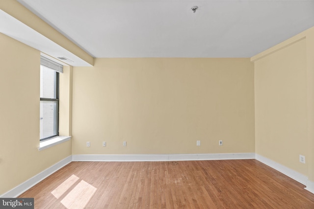 unfurnished room featuring a wealth of natural light and light hardwood / wood-style floors