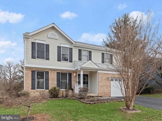 view of property with a garage and a front lawn