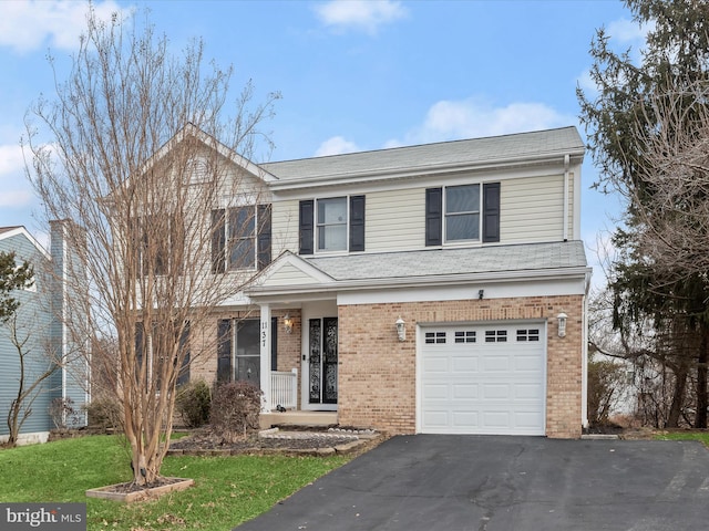 front facade with a garage and a front lawn