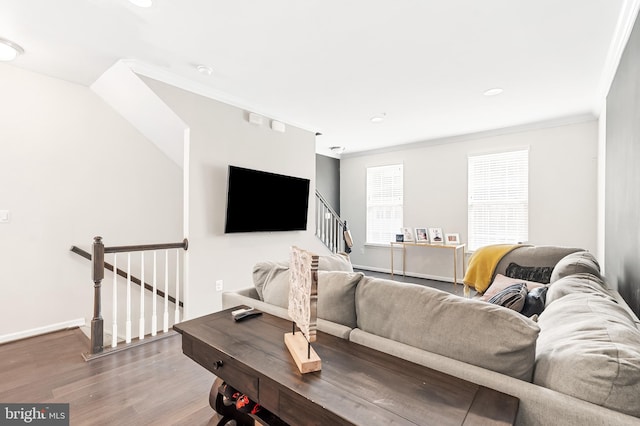 living room with stairs, crown molding, wood finished floors, and baseboards