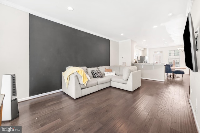 living room featuring dark wood finished floors, recessed lighting, baseboards, and ornamental molding