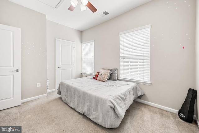 carpeted bedroom featuring visible vents, baseboards, and ceiling fan