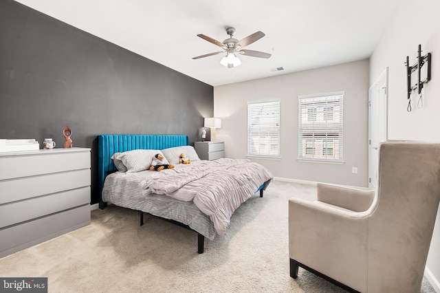 carpeted bedroom featuring visible vents, baseboards, and a ceiling fan