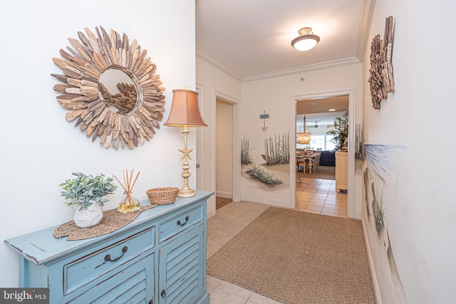 corridor featuring crown molding and light tile patterned floors