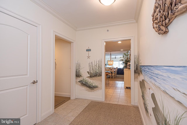 hallway with light tile patterned floors and crown molding