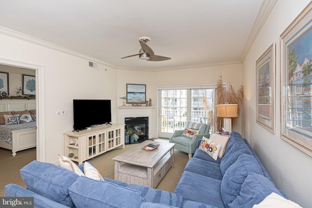 carpeted living room featuring ceiling fan and ornamental molding