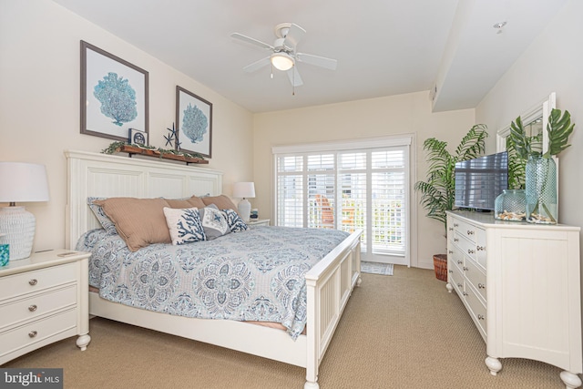 bedroom featuring light colored carpet and a ceiling fan