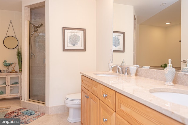 bathroom with tile patterned flooring, toilet, double vanity, a stall shower, and a sink