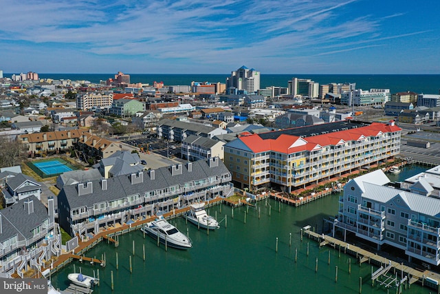 birds eye view of property featuring a city view and a water view