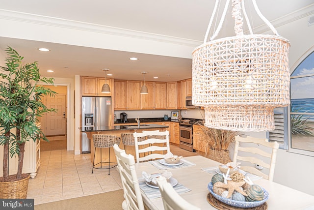 dining room featuring crown molding, light tile patterned floors, and sink