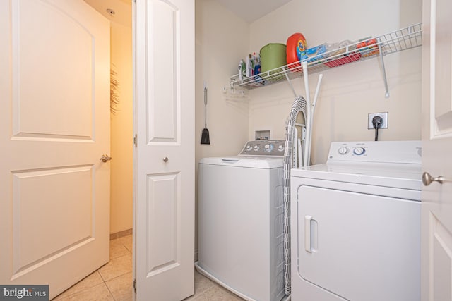 laundry area with light tile patterned floors and independent washer and dryer