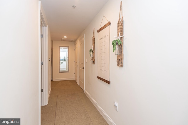 hall featuring recessed lighting and baseboards