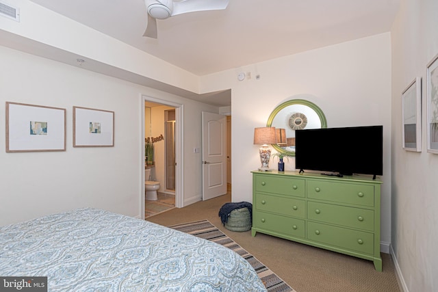 carpeted bedroom featuring visible vents, baseboards, ensuite bathroom, and a ceiling fan