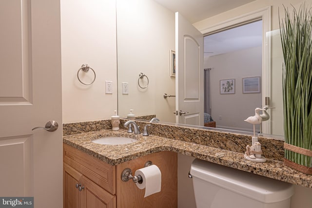 bathroom featuring vanity and toilet