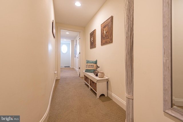 corridor featuring recessed lighting, light colored carpet, and baseboards