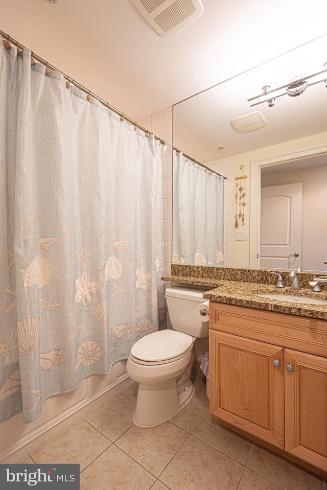 full bathroom featuring tile patterned flooring, toilet, shower / tub combo with curtain, and vanity