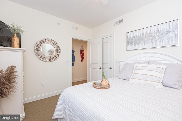 carpeted bedroom featuring visible vents, a ceiling fan, and baseboards