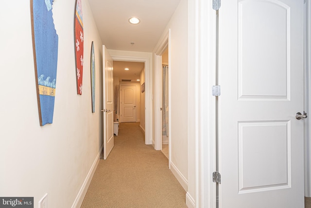 corridor with recessed lighting, baseboards, and light colored carpet