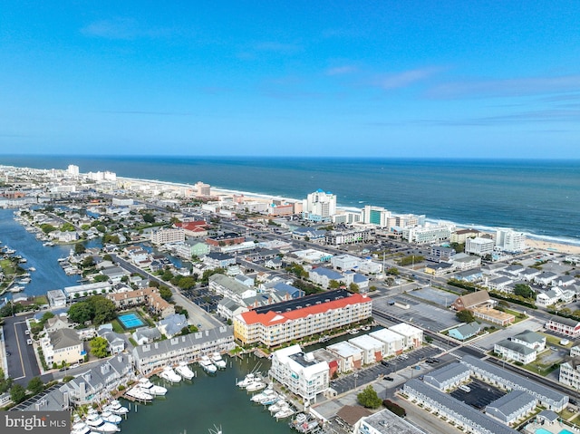 birds eye view of property with a water view and a city view