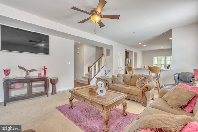 carpeted living room featuring ceiling fan