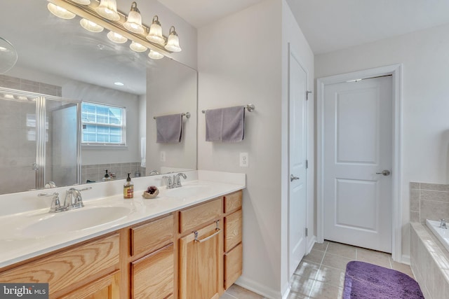 bathroom featuring independent shower and bath, vanity, and tile patterned flooring