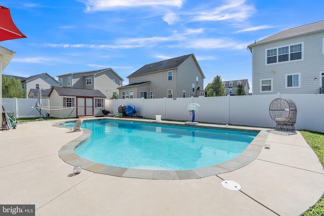 view of pool with a patio and an outbuilding