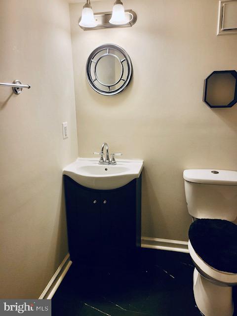 bathroom featuring vanity and toilet