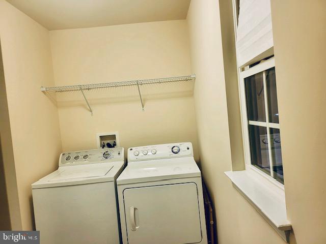 laundry area with washing machine and clothes dryer