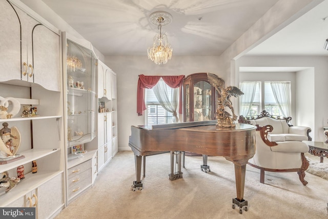 misc room featuring a notable chandelier, light carpet, and plenty of natural light