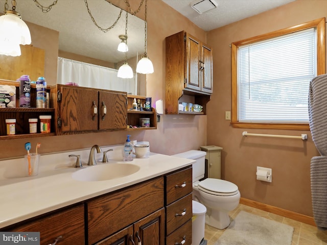 bathroom with curtained shower, tile patterned floors, a textured ceiling, toilet, and vanity