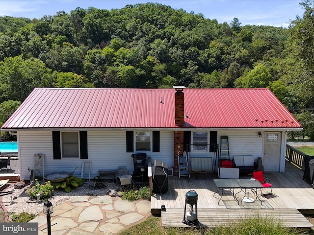 rear view of property featuring a deck