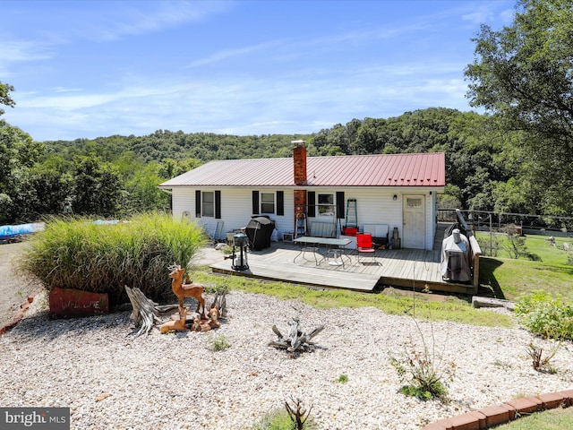 back of house featuring a deck