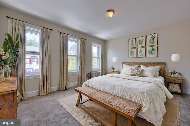 bedroom with light carpet and multiple windows