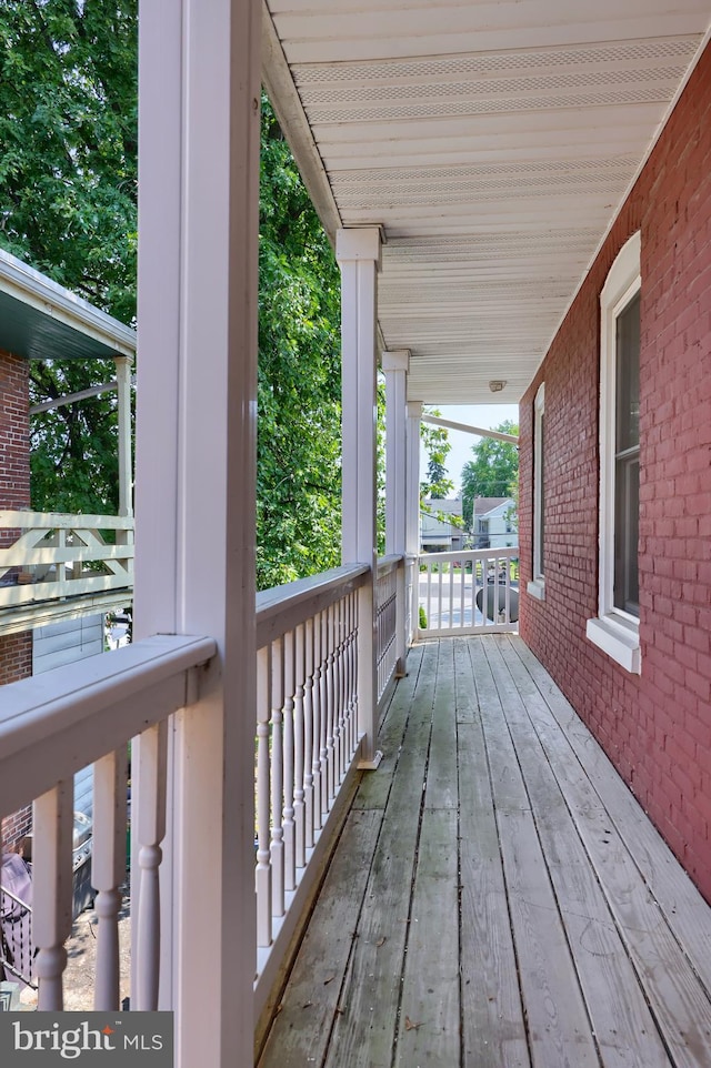 wooden terrace featuring covered porch