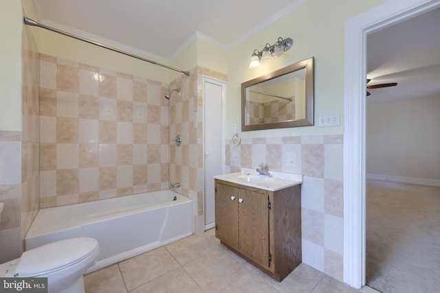 full bathroom with tiled shower / bath, tile patterned floors, toilet, ceiling fan, and vanity