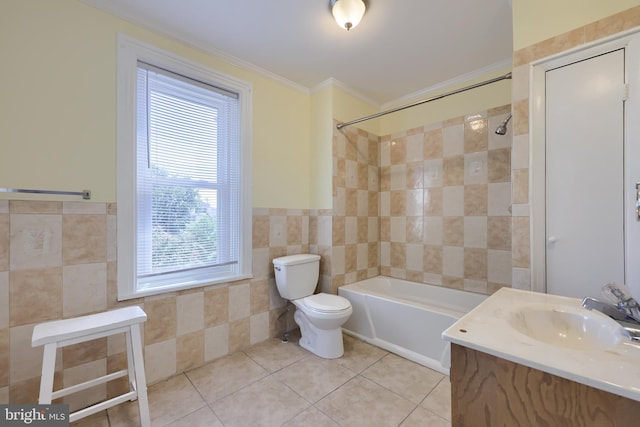 full bathroom featuring toilet, tile patterned floors, vanity, tiled shower / bath combo, and tile walls