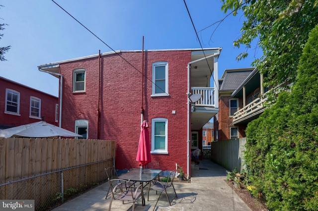 back of house with a patio area and a balcony