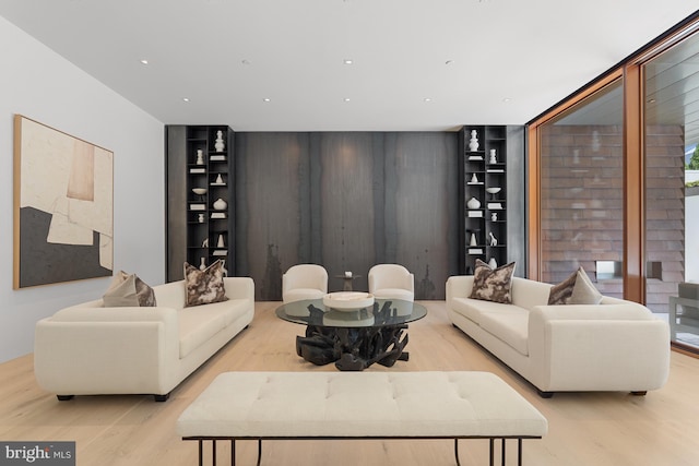 living room with light wood-type flooring and a wall of windows