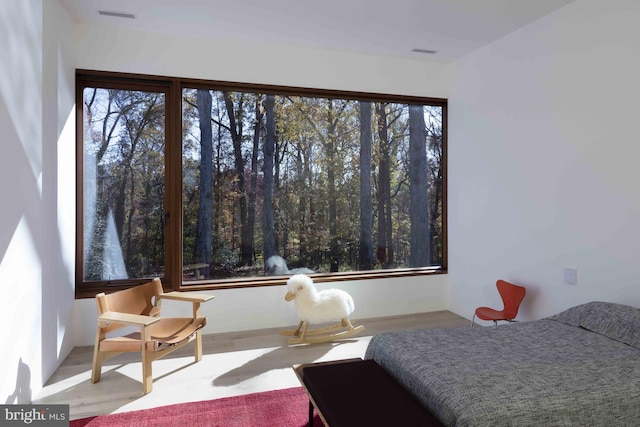 bedroom featuring multiple windows and hardwood / wood-style floors