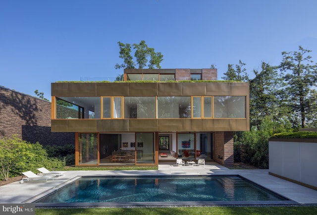 rear view of property featuring a patio area