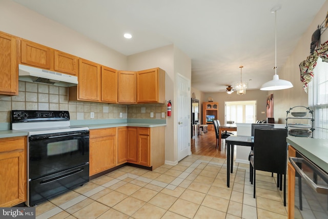 kitchen featuring black / electric stove, decorative light fixtures, light tile patterned floors, and a healthy amount of sunlight