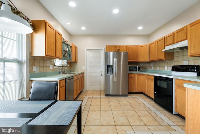 kitchen featuring appliances with stainless steel finishes, sink, decorative backsplash, and light tile patterned flooring