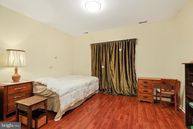 bedroom with dark hardwood / wood-style floors