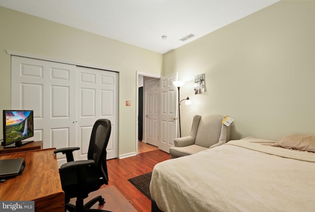 bedroom with hardwood / wood-style flooring and a closet