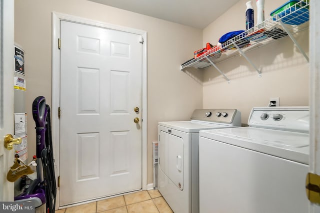 laundry room with light tile patterned floors and washer and dryer